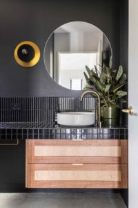 7 principals of interior design contrasting black and brushed brass in a modern bathroom with timber vanity and a plant to balance with natural elements