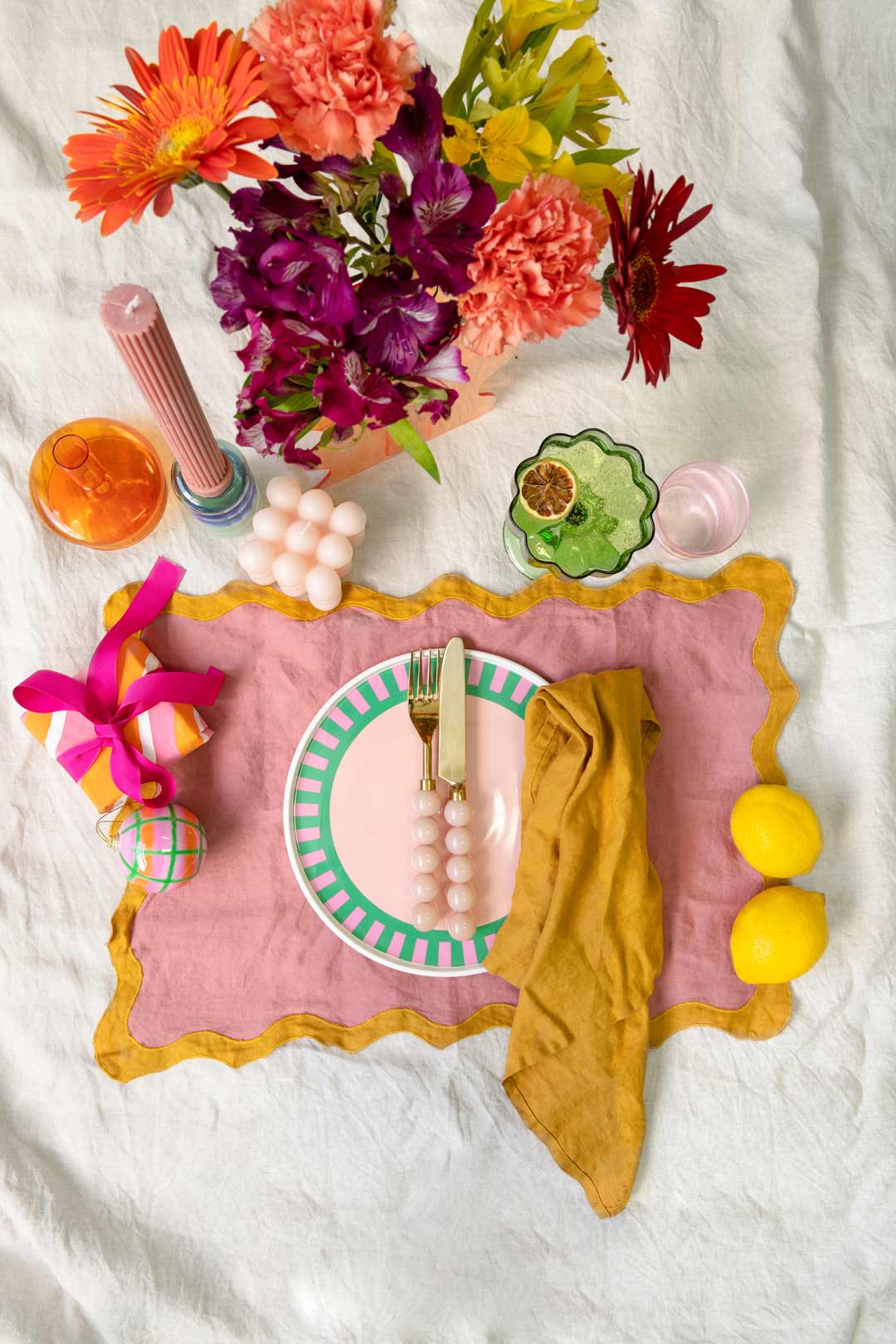 A fun bright colourful and merry Christmas table setting is the maximalist answer to what Christmas decorations are trending