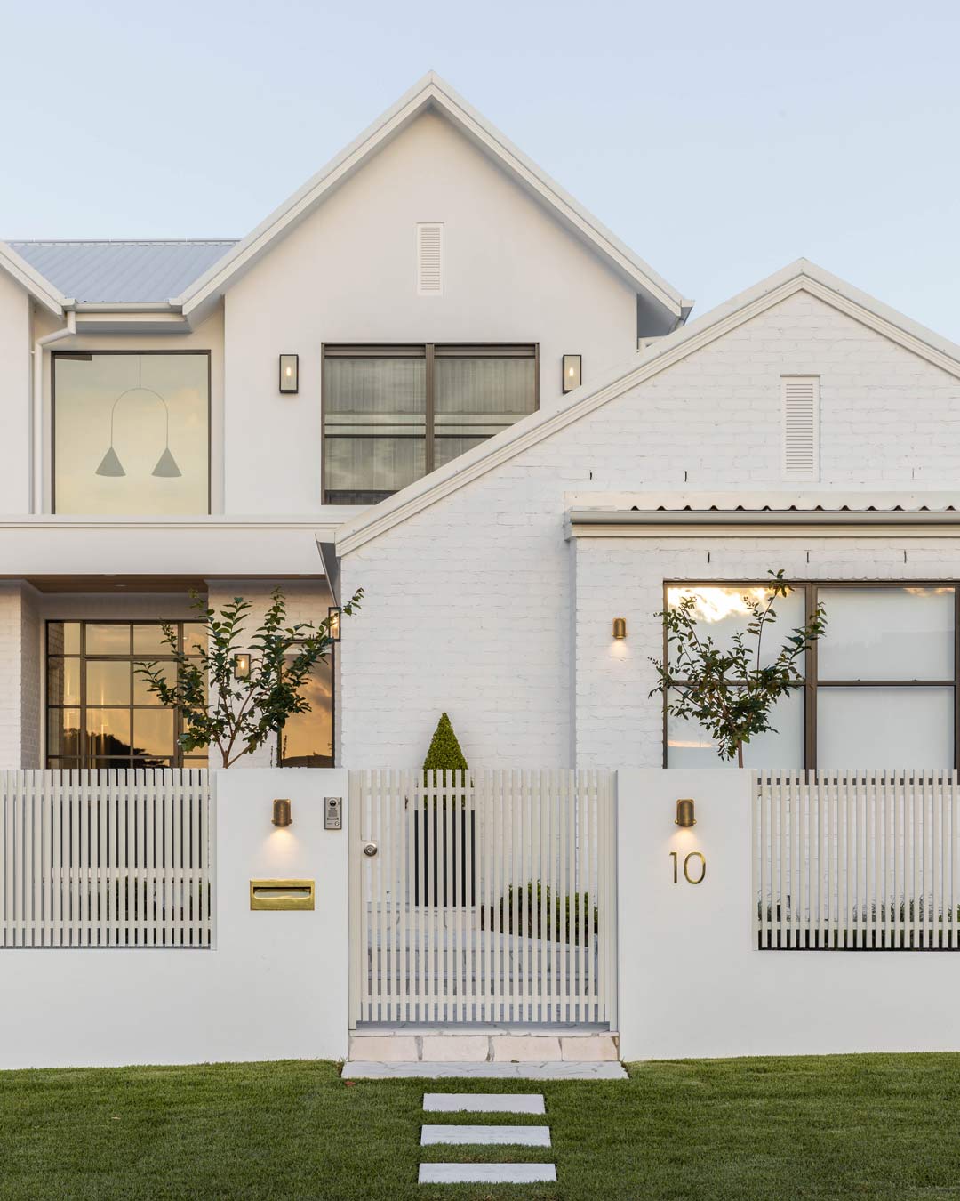 A grand elegant front entry with beautiful lighting and curb appeal