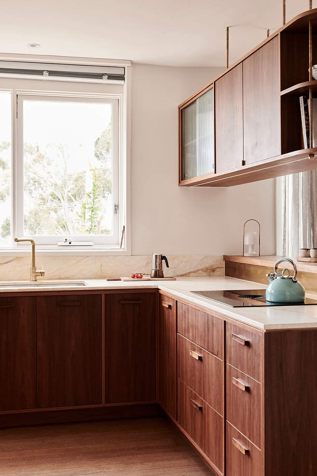 A mid centruy modern kitchen renovation with functional floating shelves and a vintage kettle