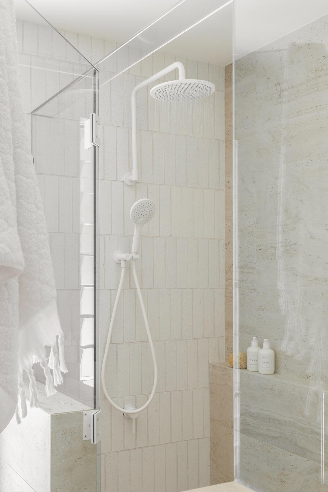 A neutral bathroom with white tapware creates an aesthetic spa like shower experience