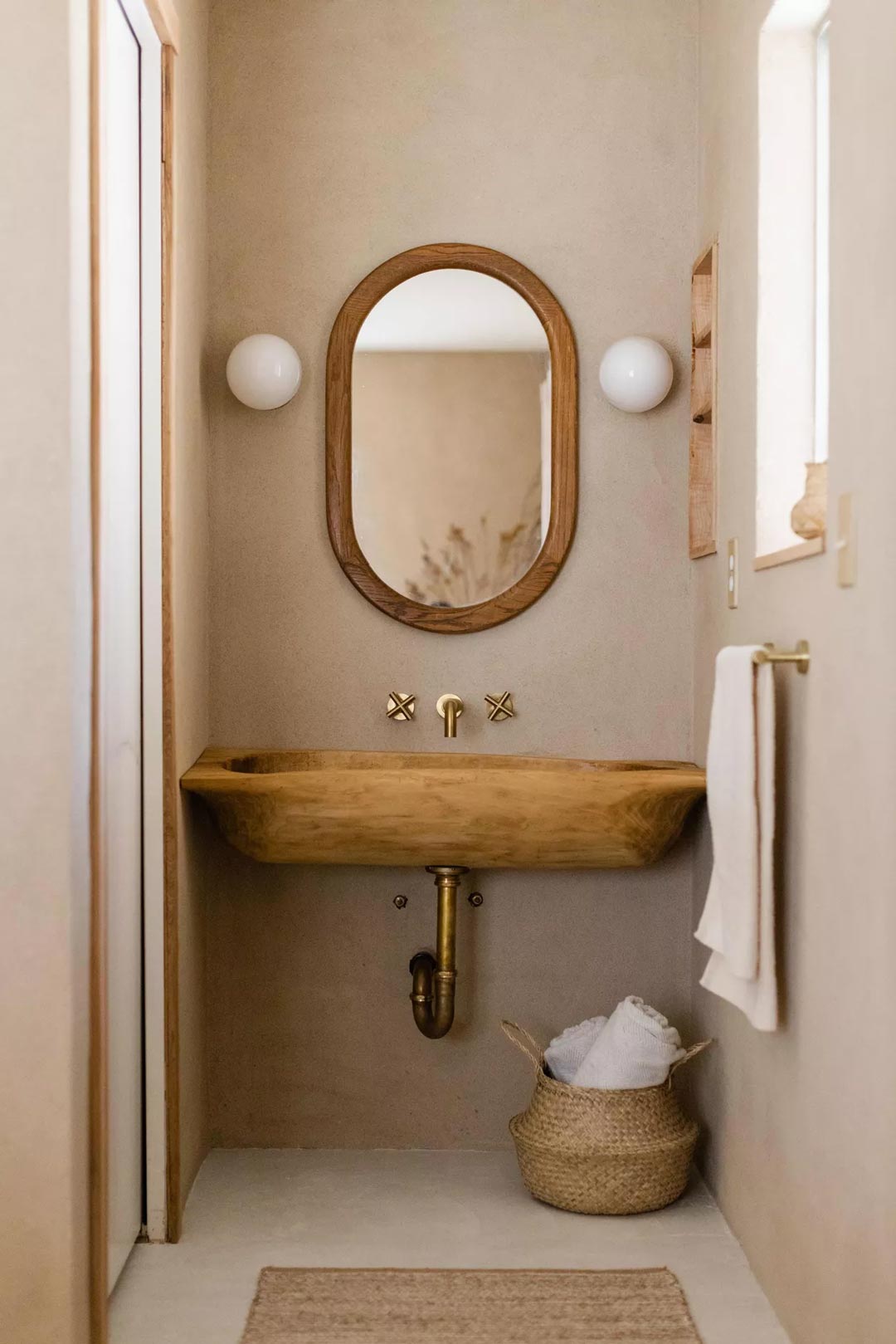 A neutral cloakroom or downstairs toilet created with natural materials and textures