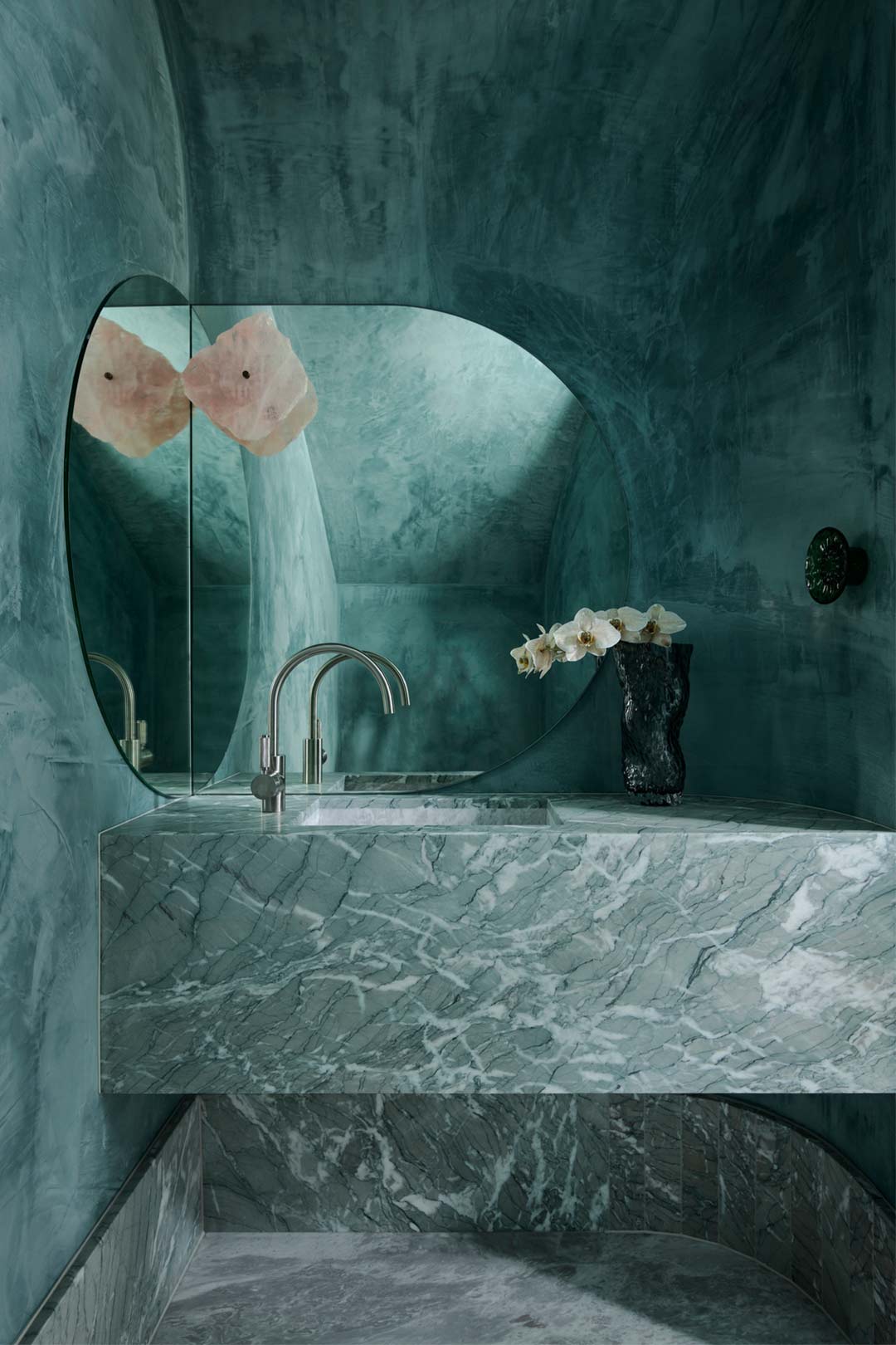 An opulant bathroom design enhanced with a monochromatic colour scheme in green