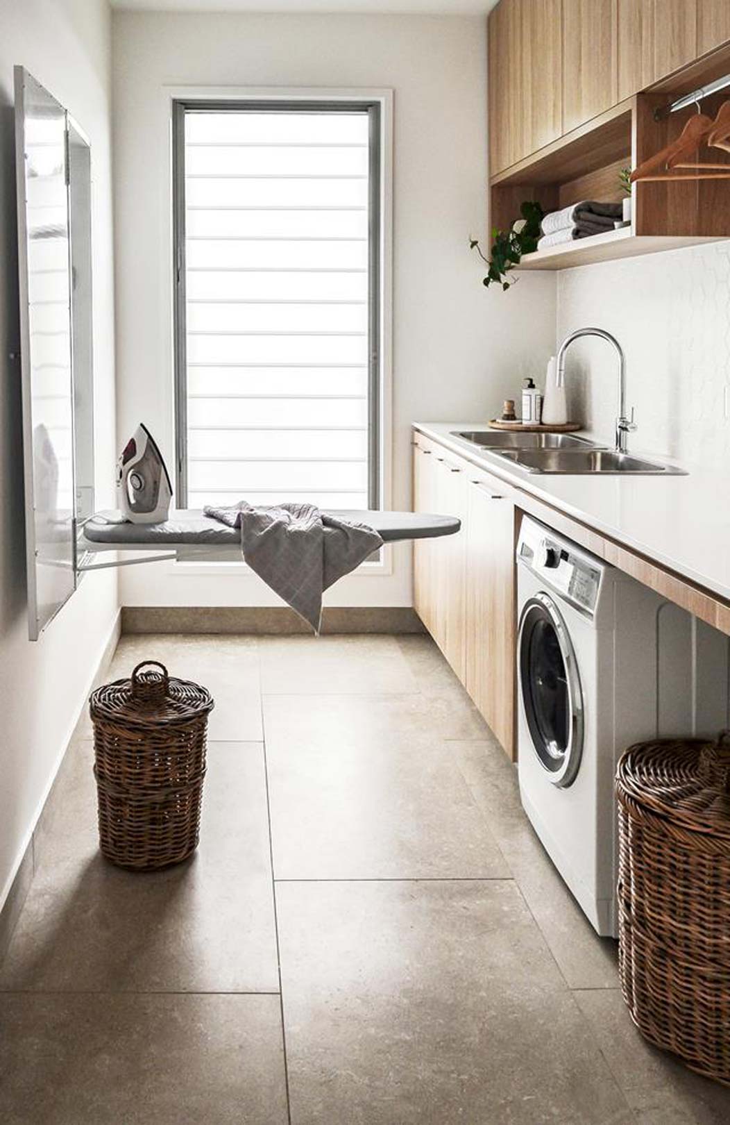 DIY small laundry room ideas include keeping your laundry tidy and a fold out hidden ironing board