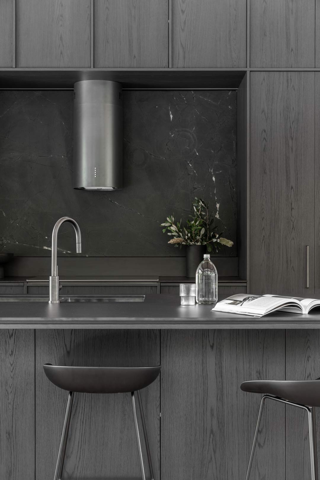 Kooringal lodge monochromatic dark modern industrial style kitchen with black cabinetry gunmetal tapware and black bar stools