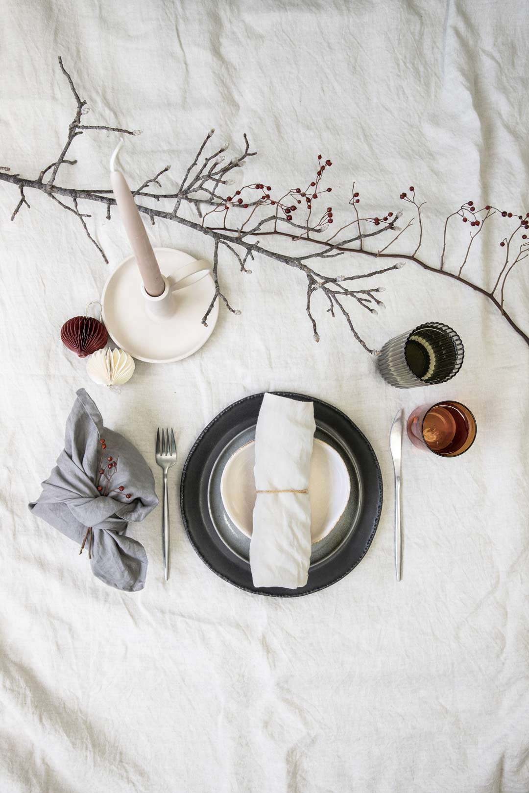 Less is more with a simple and classic take on a Japandi wabi sabi style table setting for your Christmas tablescape with a material wrapped present