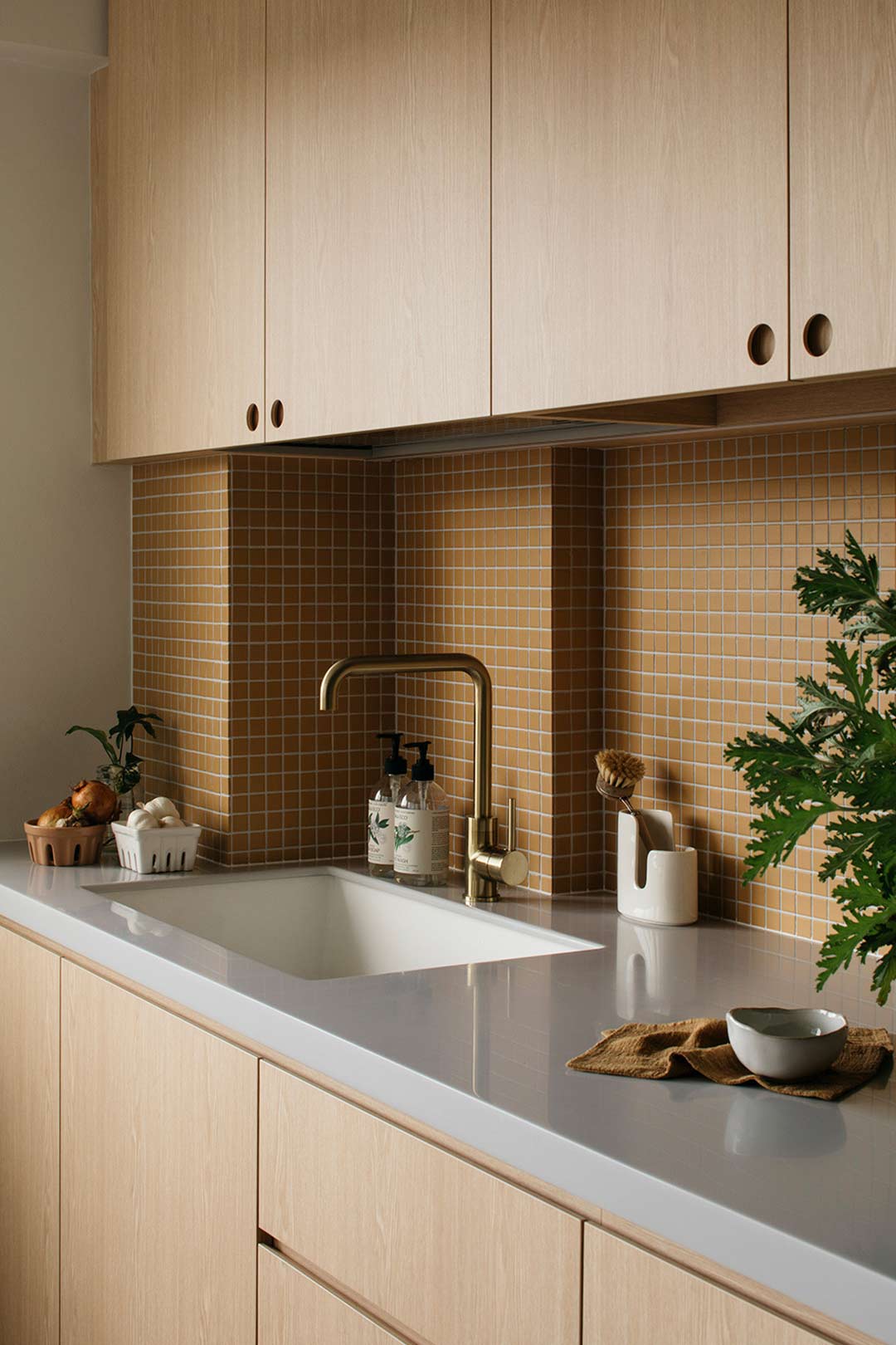 Mid century modern inspired kitchen with small mustard yellow tiles and timber cabinetry