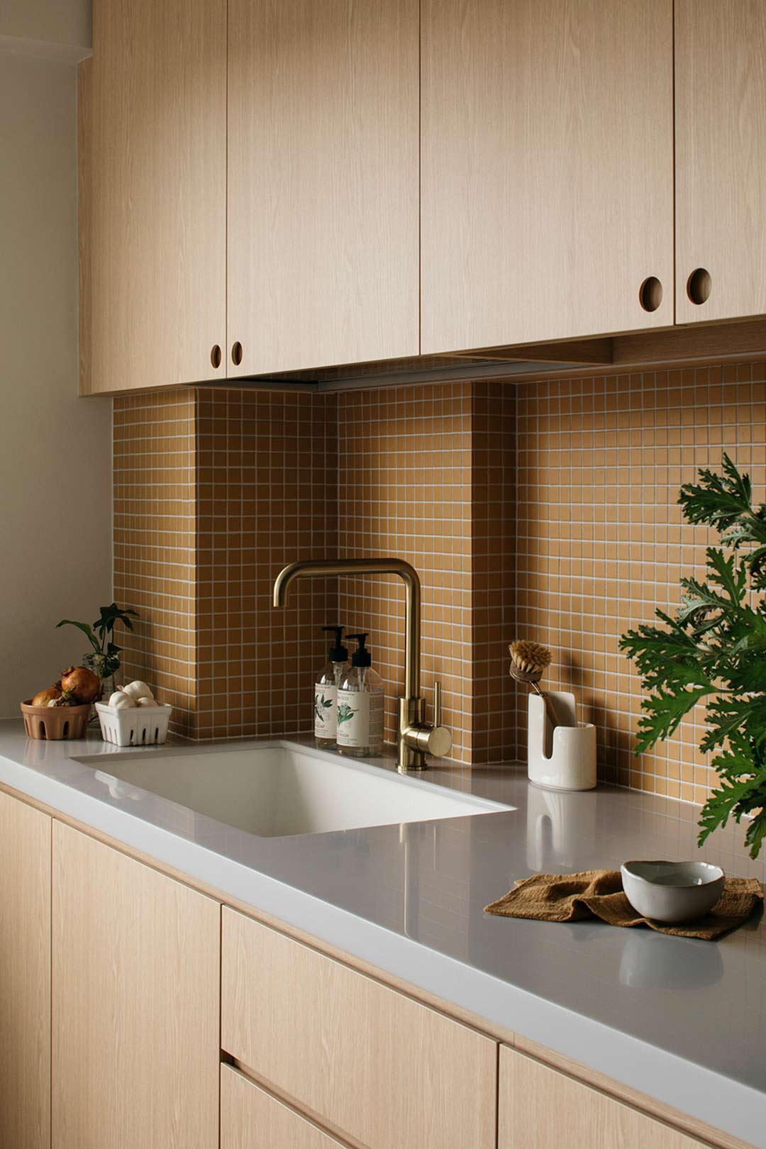Mid-century-modern-inspired-kitchen-with-small-mustard-yellow-tiles-and-timber-cabinetry