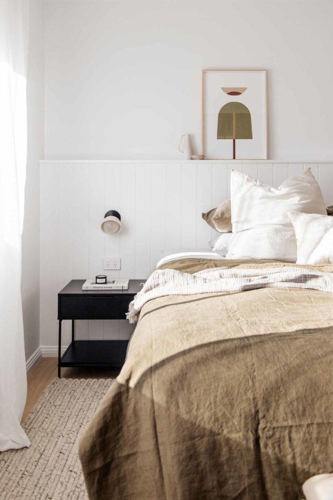 Simple and abstract bedroom wall art in olive green and neutrals above bed in mens bedroom