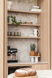 Simple home coffee bar set up seemlessly intergrated out of the way in the kitchen of modern coastal home
