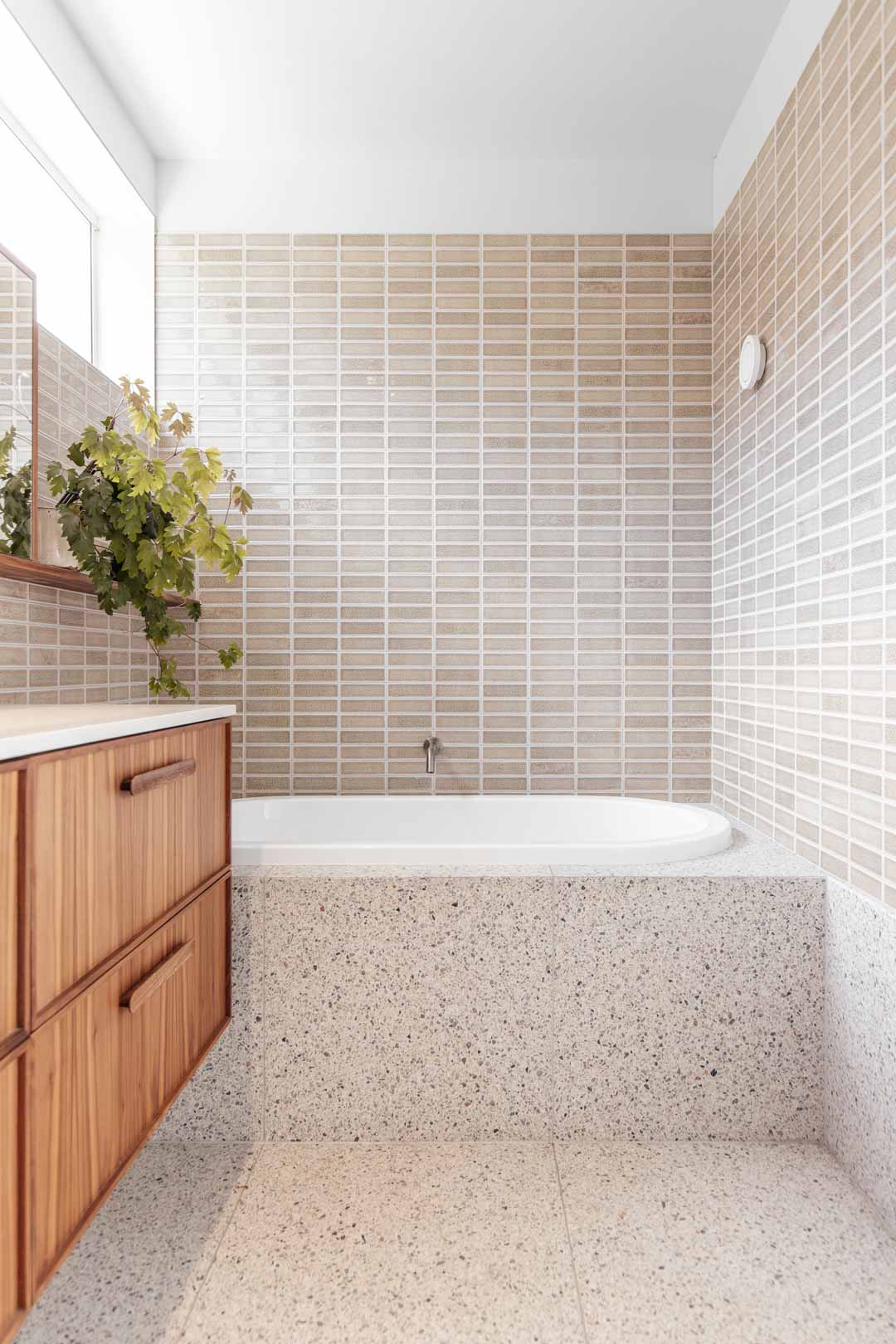 Soft indirect daylighting brightening this bathroom through high windows called clerestories