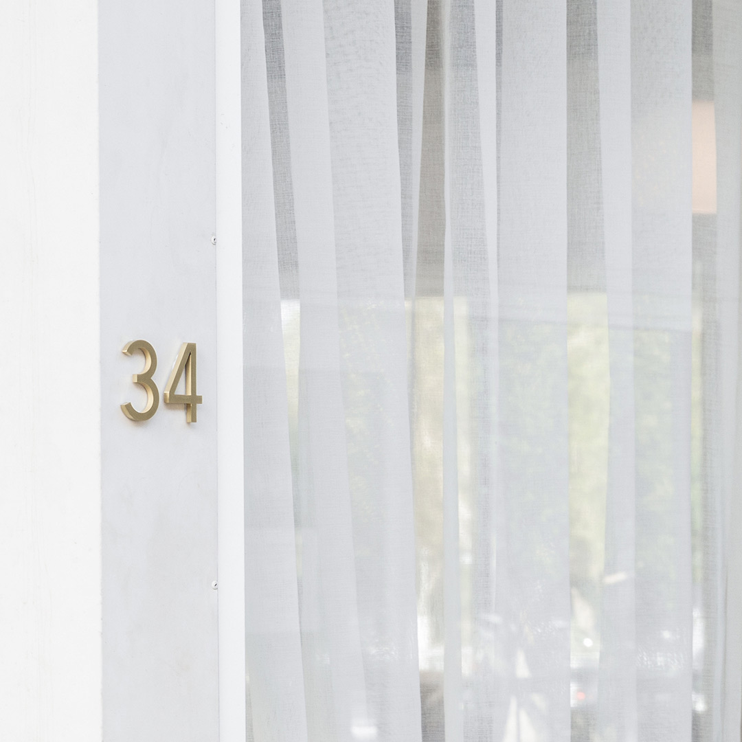 Stylish brushed brass house number signage